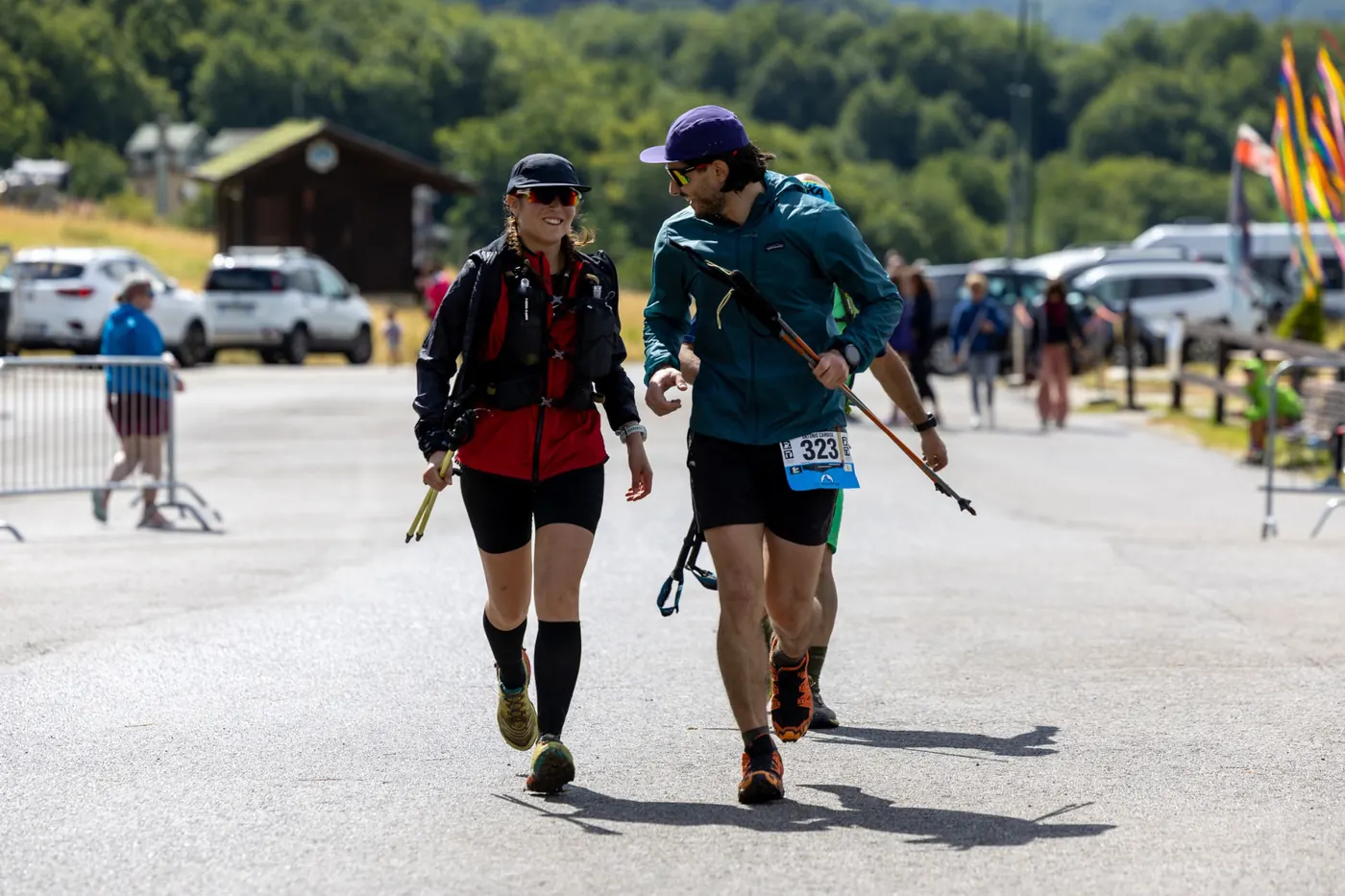 Trail runners with poles arriving at an aid station