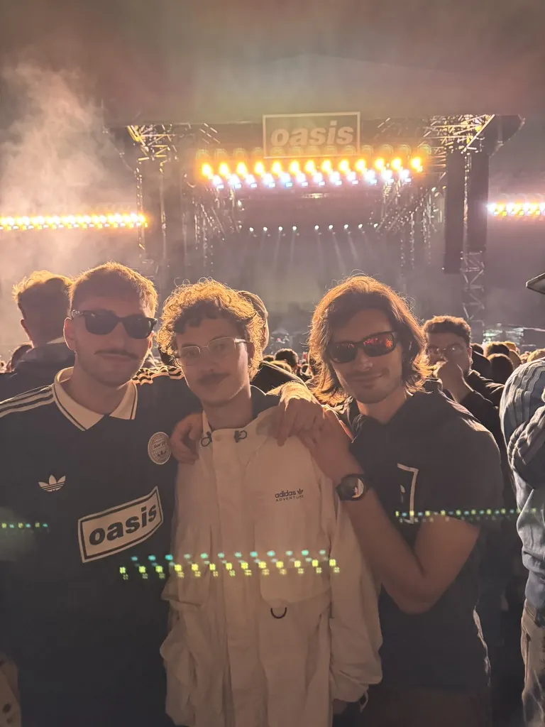 Three friends in front of the Oasis stage